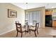 Bright dining area featuring a glass table, stylish chairs, and sliding doors to the backyard at 707 N Marotta Loop, Ocoee, FL 34761