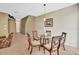 Cozy dining area with a round glass table, four chairs, and neutral decor at 707 N Marotta Loop, Ocoee, FL 34761