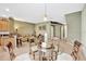 Open-concept dining area featuring a glass table and chairs next to the living room at 707 N Marotta Loop, Ocoee, FL 34761