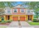 Attractive townhome with a two-car garage, manicured landscaping, and inviting curb appeal at 707 N Marotta Loop, Ocoee, FL 34761
