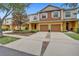 Inviting townhome with a two-car garage and well-maintained landscaping and a long driveway at 707 N Marotta Loop, Ocoee, FL 34761