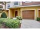 Charming townhome entrance featuring a one car garage and manicured landscaping at 707 N Marotta Loop, Ocoee, FL 34761