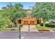 Charming townhome featuring a two-car garage, lush landscaping, and a well-maintained front yard at 707 N Marotta Loop, Ocoee, FL 34761