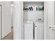 Convenient laundry closet with washer, dryer, and storage shelves at 707 N Marotta Loop, Ocoee, FL 34761
