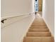 Neutral carpeted staircase with a white railing leads to the next floor in this home at 707 N Marotta Loop, Ocoee, FL 34761