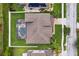 Aerial view of home featuring a screened-in pool, lush lawn, and well-maintained landscaping at 724 Duff Dr, Winter Garden, FL 34787