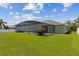 Expansive backyard with well-maintained lawn showcasing the home's screened lanai and inviting outdoor living space at 724 Duff Dr, Winter Garden, FL 34787