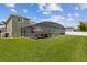 Expansive backyard with well-maintained lawn showcasing the home's screened lanai and inviting outdoor living space at 724 Duff Dr, Winter Garden, FL 34787