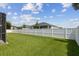 Manicured lawn and white vinyl fence enclose the serene backyard of this property at 724 Duff Dr, Winter Garden, FL 34787