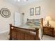 Bedroom with a bed, a mirror on the wall and natural light, creating a pleasant and inviting space at 724 Duff Dr, Winter Garden, FL 34787