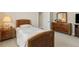 A bedroom features carpeted floors, wooden furnishings, and natural light, for a relaxing ambiance at 724 Duff Dr, Winter Garden, FL 34787