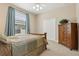 Cozy bedroom features a comfortable bed, soft carpet, and a window for natural light at 724 Duff Dr, Winter Garden, FL 34787