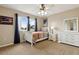 Cozy bedroom featuring neutral walls, a white bed frame and dresser, and bright natural light at 724 Duff Dr, Winter Garden, FL 34787
