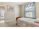 Bedroom with a window and carpeted floor offers a private space for relaxation and restful sleep at 724 Duff Dr, Winter Garden, FL 34787