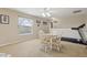 Bright bonus room with a table and chairs and a NordicTrack treadmill near a window at 724 Duff Dr, Winter Garden, FL 34787
