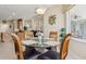 Dining area showcasing a glass-top table, seating for four, and a view into the main living area at 724 Duff Dr, Winter Garden, FL 34787