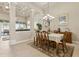 Dining room with chandelier, coffered ceiling, tile floors, and views to the lanai at 724 Duff Dr, Winter Garden, FL 34787