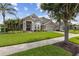 Well-maintained two-story home with stone accents, a lush front yard, and an attached two-car garage at 724 Duff Dr, Winter Garden, FL 34787