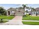 Charming two-story home with stone accents, a two-car garage, and a lush front lawn at 724 Duff Dr, Winter Garden, FL 34787