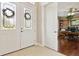 Bright foyer with decorative glass double doors, tile flooring, and a glimpse into a home office at 724 Duff Dr, Winter Garden, FL 34787
