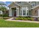 Inviting front entrance with a decorative glass door, stone accents, and well-maintained landscaping at 724 Duff Dr, Winter Garden, FL 34787