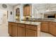 Kitchen island featuring custom cabinetry and granite countertops, perfect for meal preparation and casual dining at 724 Duff Dr, Winter Garden, FL 34787