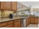 Close up of kitchen with granite counters, stainless dishwasher and access to backyard views at 724 Duff Dr, Winter Garden, FL 34787