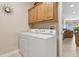 Functional laundry room featuring a modern washer and dryer next to a doorway at 724 Duff Dr, Winter Garden, FL 34787