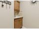 Practical laundry room featuring a sink, faucet, wooden cabinets and decorative hooks at 724 Duff Dr, Winter Garden, FL 34787