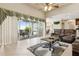 Comfortable living room featuring a ceiling fan, sliding glass doors to the lanai and outdoor views at 724 Duff Dr, Winter Garden, FL 34787