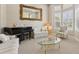 Bright living room features a piano, elegant furniture, large mirror and natural light from the windows at 724 Duff Dr, Winter Garden, FL 34787
