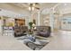 Open living space with coffered ceilings, archways and comfortable sofas at 724 Duff Dr, Winter Garden, FL 34787