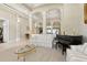 Open-concept living room with archways, high ceilings, piano and comfortable seating at 724 Duff Dr, Winter Garden, FL 34787