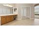 Bright main bathroom with dual sinks, lots of storage space, and tiled flooring at 724 Duff Dr, Winter Garden, FL 34787