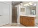 Bright main bathroom with dual sinks, a walk-in shower, and a neutral color palette at 724 Duff Dr, Winter Garden, FL 34787