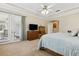 Spacious main bedroom with plush carpet, tray ceilings, and access to an outdoor patio through French doors at 724 Duff Dr, Winter Garden, FL 34787