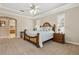 Inviting main bedroom with plush carpeting, tray ceilings, and natural light from large shuttered windows at 724 Duff Dr, Winter Garden, FL 34787