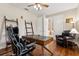 Comfortable home office with hardwood floors, natural light, and a classic executive desk and chair at 724 Duff Dr, Winter Garden, FL 34787