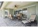 Covered outdoor patio with table and chairs, a lounge chair, and sliding glass doors to the home's interior at 724 Duff Dr, Winter Garden, FL 34787