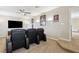Home theater featuring tiered seating with leather recliners and large flat screen television at 724 Duff Dr, Winter Garden, FL 34787
