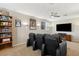 Home theater features tiered seating with leather recliners and large flat screen television at 724 Duff Dr, Winter Garden, FL 34787