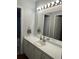 Bathroom featuring a sink and white cabinets, providing storage space and a clean aesthetic at 816 Polo Park East Blvd, Davenport, FL 33897