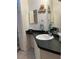 Bathroom featuring a decorative shower curtain, drawers, a sink, and dark countertops at 816 Polo Park East Blvd, Davenport, FL 33897