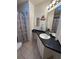 This bathroom has a decorative shower curtain, drawers, a sink and dark countertops at 816 Polo Park East Blvd, Davenport, FL 33897