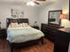 Comfortable bedroom features wood floors, a plush bed with decorative pillows, and tasteful décor at 816 Polo Park East Blvd, Davenport, FL 33897