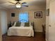 Cozy bedroom featuring hardwood floors, neutral paint, and a comfortable daybed with olive pillows at 816 Polo Park East Blvd, Davenport, FL 33897