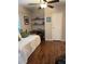 Bedroom featuring hardwood floors, neutral paint, floating shelves, and a comfortable daybed at 816 Polo Park East Blvd, Davenport, FL 33897