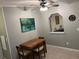 Cozy dining area features a wooden table set, soft neutral paint, and a ceiling fan for comfortable meals at 816 Polo Park East Blvd, Davenport, FL 33897