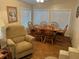 Bright dining area featuring hardwood floors, natural light from windows, and comfortable seating at 816 Polo Park East Blvd, Davenport, FL 33897