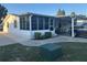 Well-maintained single-story home with a screened porch and covered parking at 816 Polo Park East Blvd, Davenport, FL 33897